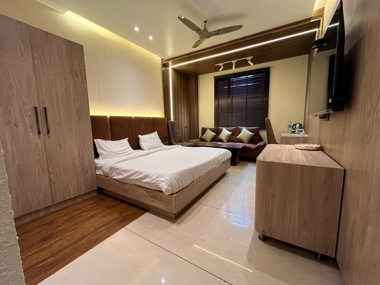 Classic Room Hotel Flora Haridwar - modern interior with sofa and wardrobe
